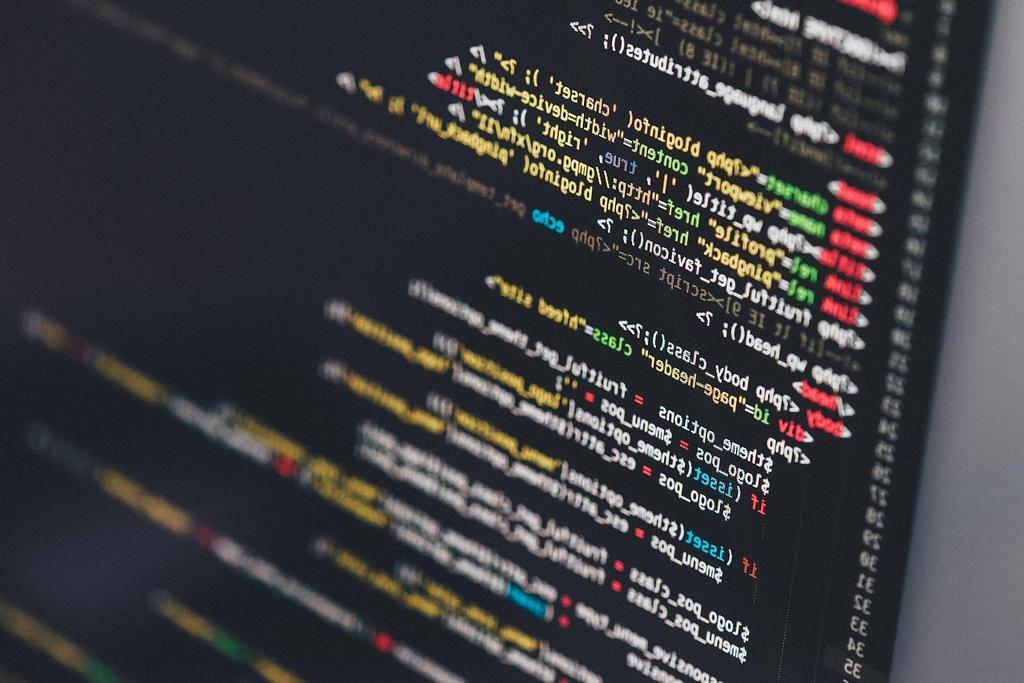 Laptop displaying software code and debugging interface
